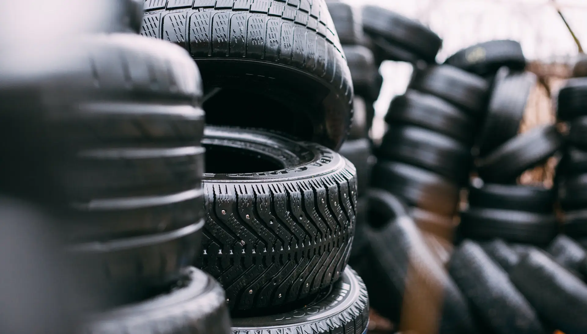 pile of car tyres in the foreground and background
