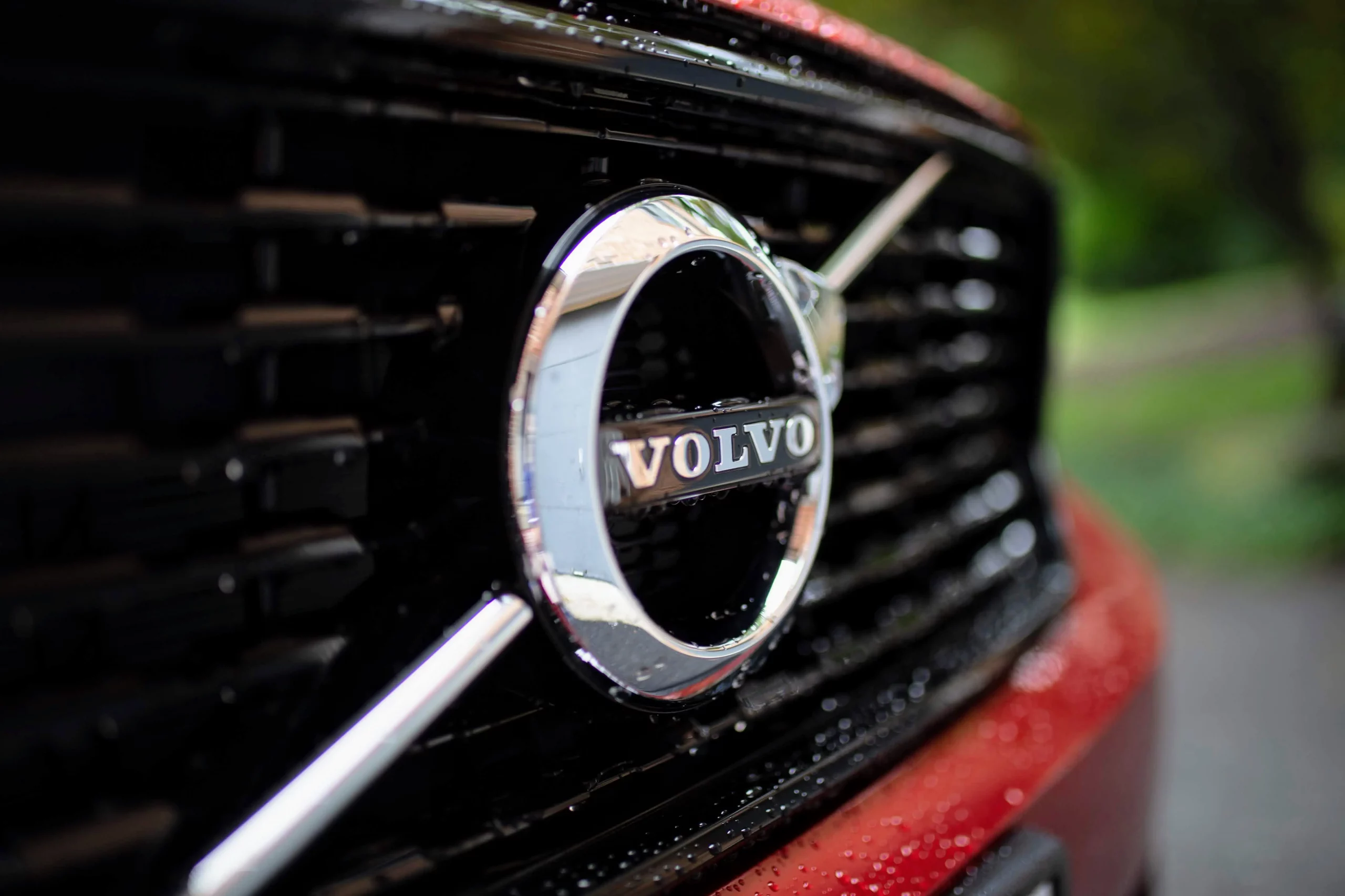 close up of the logo on a red volvo car